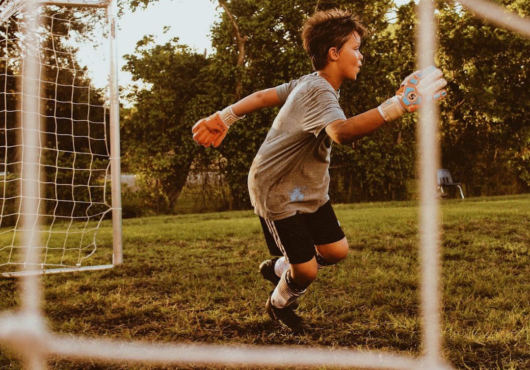 Berkeley teen playing soccer on a school field wearing Invisalign Teen aligners