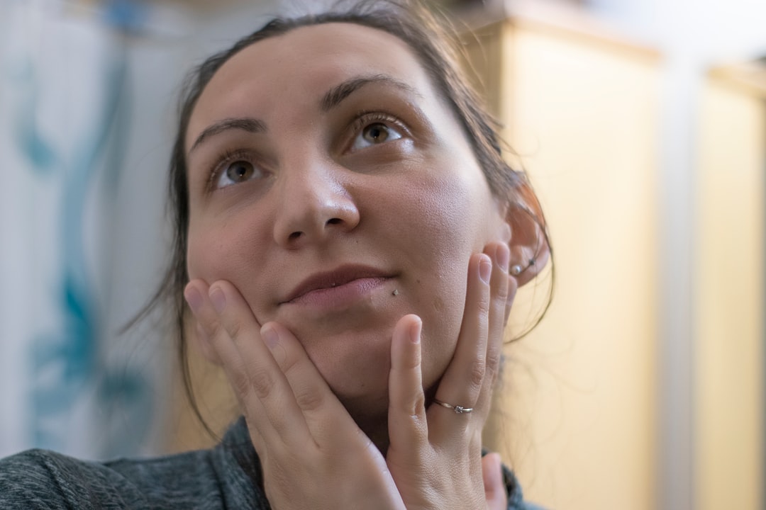 Woman gently checking her cheek and lip a few hours after a dental filling in Berkeley