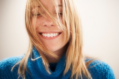 Woman smiling after her bad breath was resolved