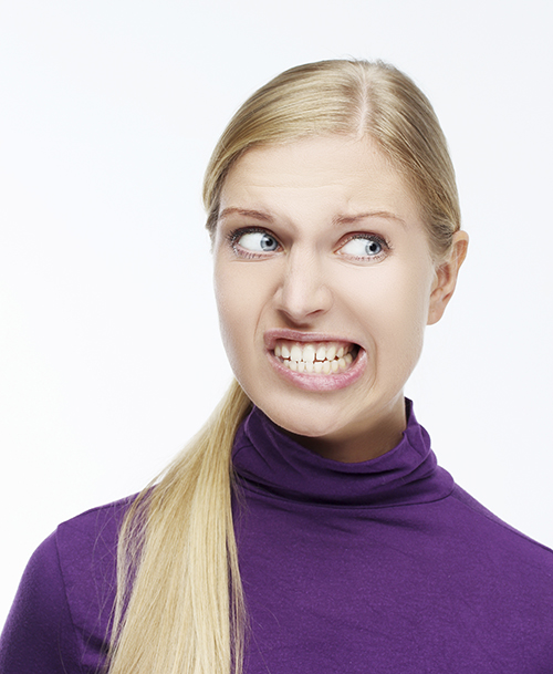 Woman grinding teeth who could use bruxism treatment at Anthony Dailley, DDS