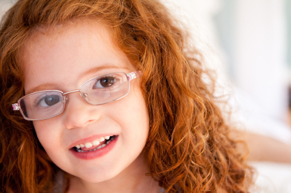 Smiling child with glasses.